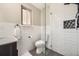 Modern bathroom featuring subway tile walls, a glass shower door, and contemporary fixtures at 8102 S Carr Ct, Littleton, CO 80128