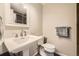 Bathroom with a pedestal sink and mirror. The space is brightly lit and well-maintained at 8102 S Carr Ct, Littleton, CO 80128