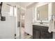 Updated bathroom with a glass shower door and a dark wood vanity at 8102 S Carr Ct, Littleton, CO 80128