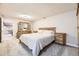 Bedroom boasts natural wood furniture, ample natural light, and neutral walls at 8102 S Carr Ct, Littleton, CO 80128