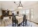 Inviting dining area with French doors leading to the outdoors and an adjacent living room at 8102 S Carr Ct, Littleton, CO 80128