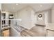 Bright foyer with wood floors, white trim, and a view of the staircase and front door at 8102 S Carr Ct, Littleton, CO 80128