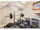 Home gym featuring weightlifting equipment, dumbbells, and ample workout space at 8102 S Carr Ct, Littleton, CO 80128