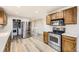 Modern kitchen featuring stainless steel appliances and wood cabinets at 8102 S Carr Ct, Littleton, CO 80128