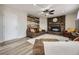 Cozy living room with a brick fireplace, wood accent wall, and comfortable seating at 8102 S Carr Ct, Littleton, CO 80128