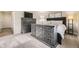 Comfortable bedroom featuring a bed with nightstands and dresser for storage at 8102 S Carr Ct, Littleton, CO 80128