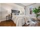 This bedroom features wood flooring, a cushioned headboard, and large window at 601 W 11Th Ave # 1101, Denver, CO 80204