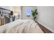 Comfortable bedroom with wood floors, stylish decor, and a large window overlooking the city at 601 W 11Th Ave # 1101, Denver, CO 80204