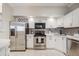 Modern kitchen with stainless steel appliances, white cabinets, and subway tile backsplash at 601 W 11Th Ave # 1101, Denver, CO 80204