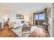 Bright living room featuring a white sofa, modern rug, and sliding glass doors to a balcony at 601 W 11Th Ave # 1101, Denver, CO 80204