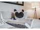 Close-up of a stylish sofa with decorative pillows and a throw blanket, illuminated by a modern floor lamp at 601 W 11Th Ave # 1101, Denver, CO 80204