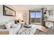 Bright living room featuring a white sofa, modern rug, and sliding glass doors to a balcony at 601 W 11Th Ave # 1101, Denver, CO 80204