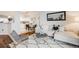 Inviting living room showcasing a white sectional sofa, modern rug, and open access to the dining area at 601 W 11Th Ave # 1101, Denver, CO 80204