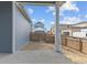 View of fenced backyard with blue siding and concrete patio at 21202 E 63Rd Dr, Aurora, CO 80019