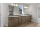 Bathroom featuring double vanity, granite countertops, tile floor, and glass-enclosed shower at 21202 E 63Rd Dr, Aurora, CO 80019