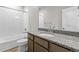 Bathroom features a granite countertop, bathtub, and white tiling at 21202 E 63Rd Dr, Aurora, CO 80019