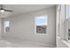 Bedroom featuring a ceiling fan and large windows with outside view at 21202 E 63Rd Dr, Aurora, CO 80019