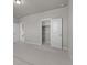 Bedroom featuring an open closet and access to the hallway at 21202 E 63Rd Dr, Aurora, CO 80019