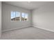 Bright bedroom with plush carpeting and a large window with a community view at 21202 E 63Rd Dr, Aurora, CO 80019