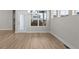 Dining area features wood laminate flooring and view to outdoor patio at 21202 E 63Rd Dr, Aurora, CO 80019