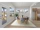 Modern dining room featuring a stylish table setting, ample natural light, and hardwood floors at 21202 E 63Rd Dr, Aurora, CO 80019
