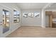 Bright dining room with wood laminate flooring, and outdoor views at 21202 E 63Rd Dr, Aurora, CO 80019