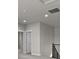 Hallway featuring overhead lighting, staircase, and a bedroom at 21202 E 63Rd Dr, Aurora, CO 80019