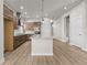 Island kitchen with stainless appliances, plenty of storage, and modern finishes at 21202 E 63Rd Dr, Aurora, CO 80019