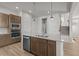 Kitchen island with stainless steel appliances, tile backsplash, and pendant lighting at 21202 E 63Rd Dr, Aurora, CO 80019