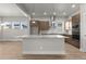 Spacious kitchen island, stainless steel appliances, light countertops, and brown cabinets at 21202 E 63Rd Dr, Aurora, CO 80019