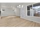Open-concept living space with wood laminate flooring and lots of natural light at 21202 E 63Rd Dr, Aurora, CO 80019