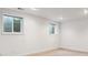 Unfinished basement features neutral carpet, two windows, and recessed lighting at 7641 S Rosemary Cir, Centennial, CO 80112