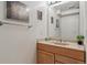 Bathroom features wood vanity, neutral countertops, one sink, and artwork on the wall at 7641 S Rosemary Cir, Centennial, CO 80112