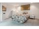 Bedroom featuring neutral colors, carpet, and a floral bedspread with decorative pillows at 7641 S Rosemary Cir, Centennial, CO 80112