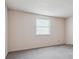 Bedroom with gray carpet and a window with blinds, creating a simple and clean design at 7641 S Rosemary Cir, Centennial, CO 80112