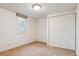 Bedroom features neutral carpet, one window, and a closet with a double door at 7641 S Rosemary Cir, Centennial, CO 80112