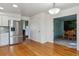 Open dining area with stainless steel refrigerator, hardwood floors and access to dining room at 7641 S Rosemary Cir, Centennial, CO 80112