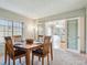 Cozy dining room with wooden table set for four, view to kitchen, and carpeted floor at 7641 S Rosemary Cir, Centennial, CO 80112
