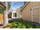 Exterior features yellow siding, a wood fence, mature trees, and stone pathway at 7641 S Rosemary Cir, Centennial, CO 80112