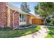 Charming brick and siding home with a well-maintained lawn and beautiful landscaping at 7641 S Rosemary Cir, Centennial, CO 80112