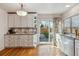 Bright kitchen with white cabinets, stainless steel appliances, and access to outdoor space at 7641 S Rosemary Cir, Centennial, CO 80112