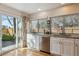 Bright kitchen with stainless steel appliances, plenty of counter space, and access to the backyard at 7641 S Rosemary Cir, Centennial, CO 80112