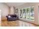 Inviting living room with hardwood floors, large windows and a comfortable sofa at 7641 S Rosemary Cir, Centennial, CO 80112