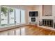 Bright living room with hardwood floors, a fireplace, and a large window with scenic views at 7641 S Rosemary Cir, Centennial, CO 80112