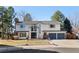 Two-story home boasts a three car garage, charming front yard and brick detailing at 7647 S Crocker Ct, Littleton, CO 80120