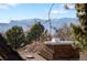 Scenic view of the mountains from this home through the surrounding trees and rooftop at 7647 S Crocker Ct, Littleton, CO 80120