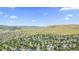 Aerial neighborhood view with rolling hills and scenic surroundings at 14185 W Warren Cir, Lakewood, CO 80228