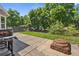 Backyard patio area featuring a fire pit and grill, perfect for entertaining with lawn and landscaping at 14185 W Warren Cir, Lakewood, CO 80228