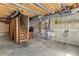 Unfinished basement with exposed beams, stairs, utility sink, and potential for customization at 14185 W Warren Cir, Lakewood, CO 80228