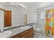 Full bathroom with double vanity and shower-tub combination at 14185 W Warren Cir, Lakewood, CO 80228